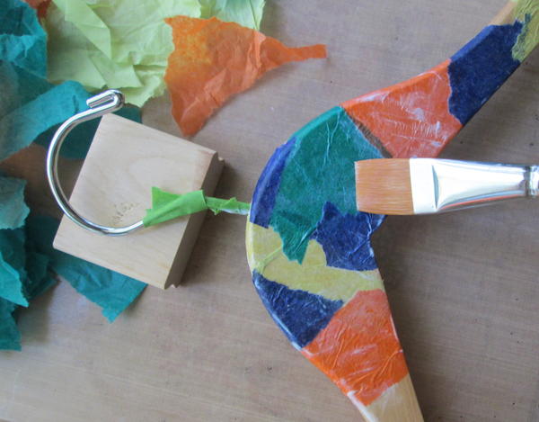 Pick up a second tissue piece with the brush. Overlapping edges slightly, position and attach, wrapping carefully around hanger edge and around the metal hanger area. Pick up a second tissue piece with the brush. Overlapping edges slightly, position and attach, wrapping carefully around hanger edge and around the metal hanger area.
