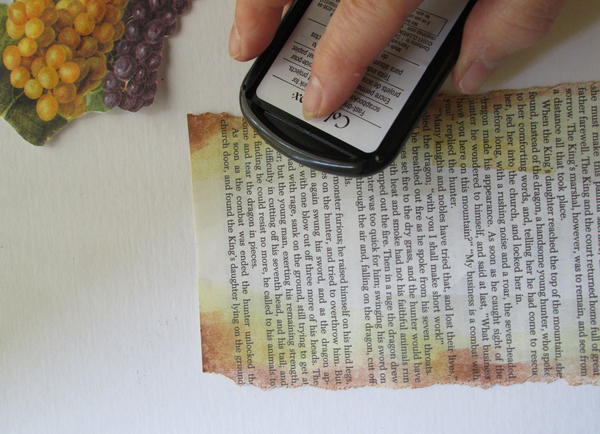 Place book page flat on work table. Hand tear the long edges. Using art daubers, apply ink (from light to dark) around the edges of the page; dry. Place book page flat on work table. Hand tear the long edges. Using art daubers, apply ink (from light to dark) around the edges of the page; dry.