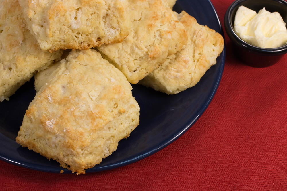 A plate of finished homemade buttermilk biscuits made from puff pastry