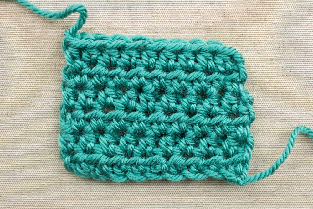 Beginner soft stripes and dot border crochet baby blanket How to Half Double Crochet Video Tutorial | AllFreeCrochet.com